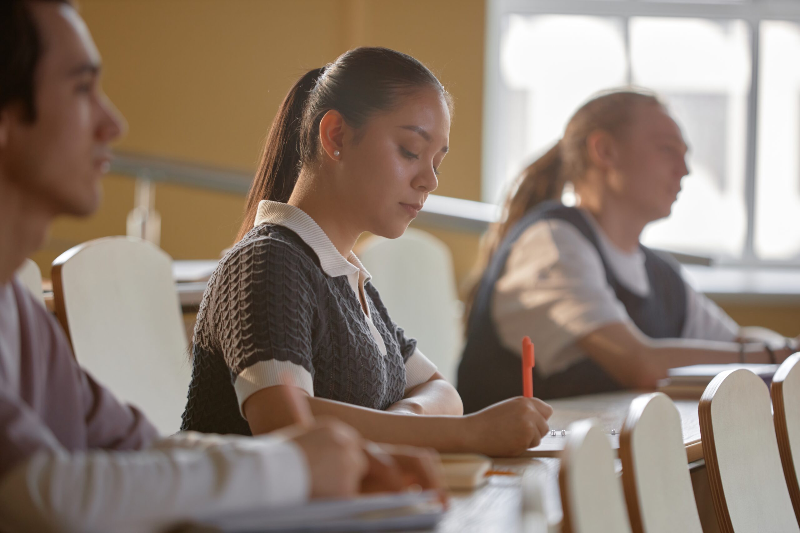 young-female-college-learner-writing-lecture-at-un-2026-01-08-22-22-42-utc-scaled